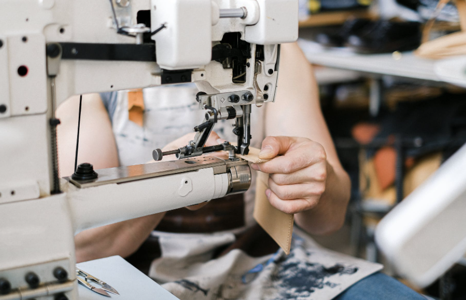 a person sewing on a sewing machine